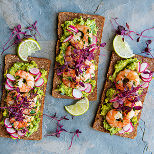 German Rye Bread with Shrimps, Avocado Puree and Radishes